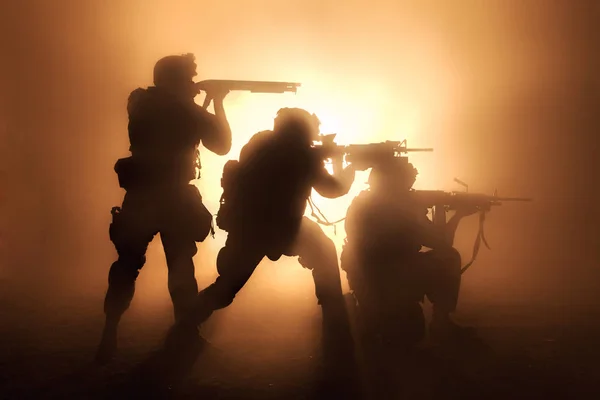 Two attacking soldiers surrounded flame and smoke