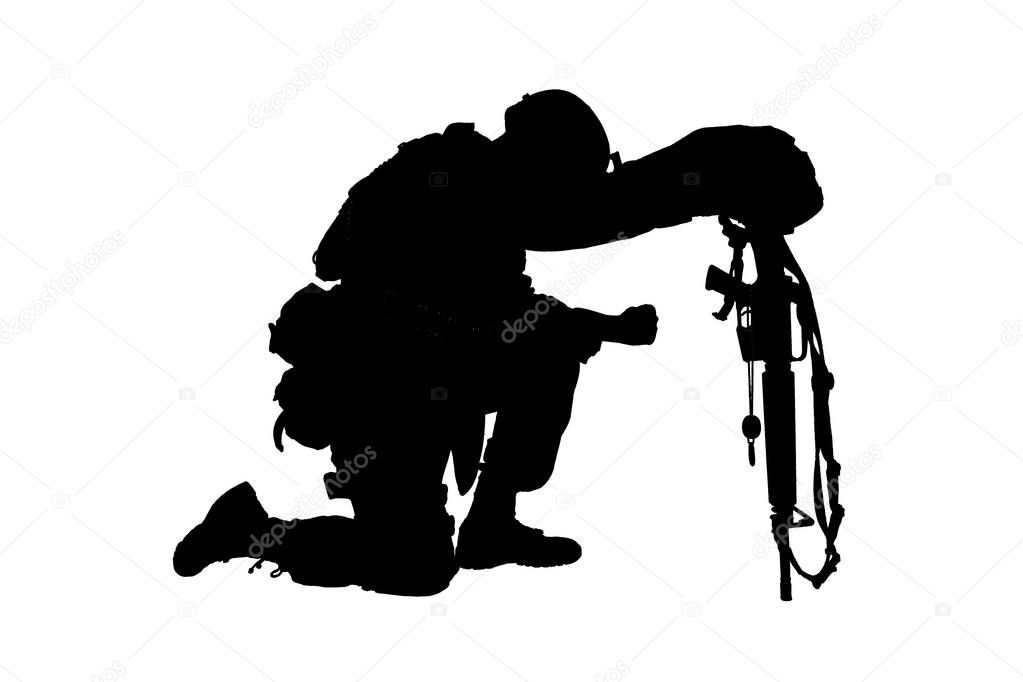 Sad soldier kneeling because of friend death