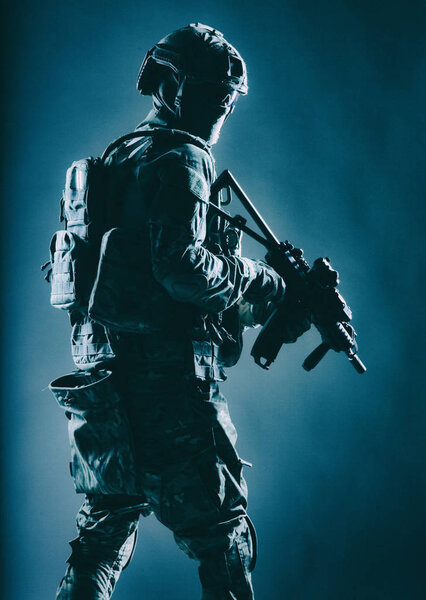 Special operations forces soldier in darkness studio