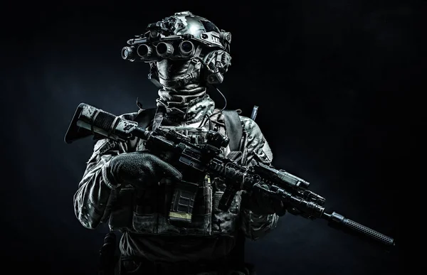 Modern combatant wearing night vision device black background