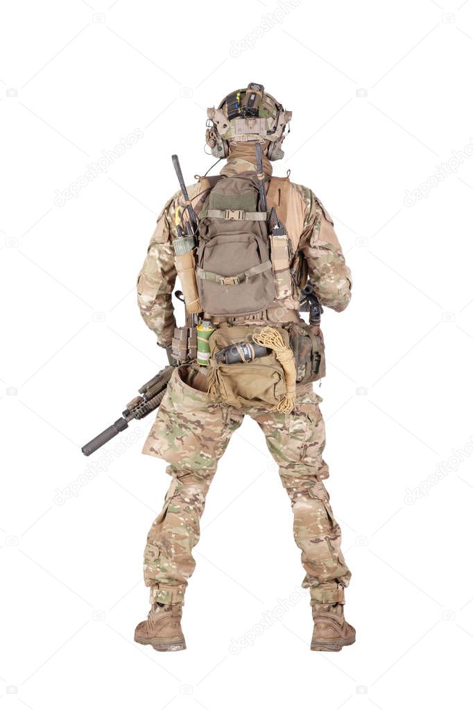 Armed army soldier standing backwards studio shoot