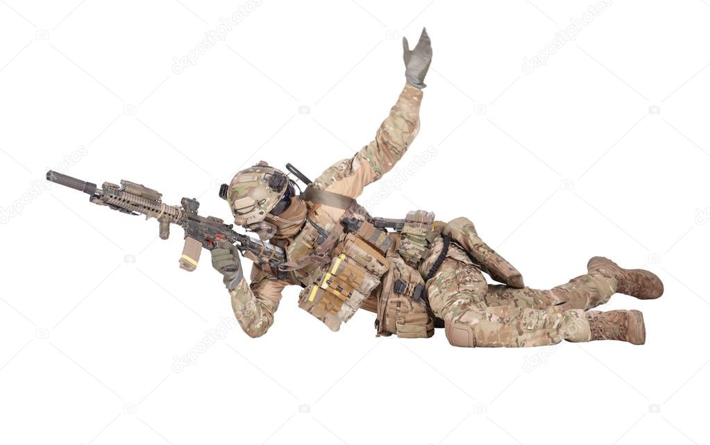 Soldier shooting from ground isolated studio shoot