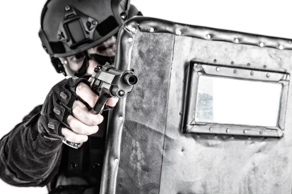 SWAT team fighter aiming pistol from behind shield — Stock Photo, Image