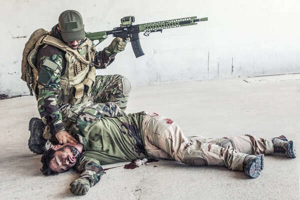 Солдат проверяет пульс раненого товарища.