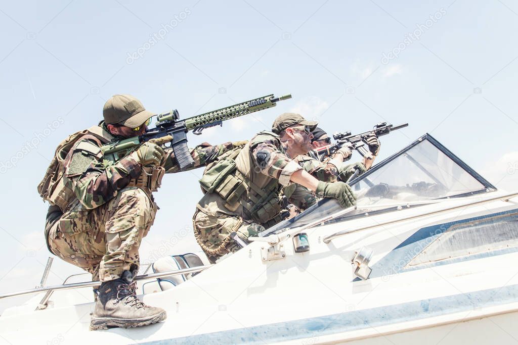 Navy SEALs soldiers chasing enemy on speed boat