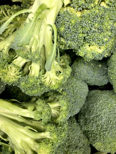 Green broccoli with drops of water, healthy nutritious vegetable that is low calorie with vitamins and nutrients, farmer\'s market produce or cooking ingredient for recipes, vegan or vegetarian cuisine