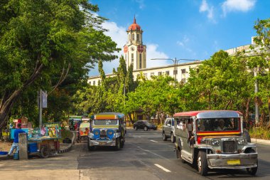street view of manila with jeepney and clock tower clipart