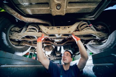 Araba tamircisi araba süspansiyon kaldırdı otomobil tamir hizmet istasyonu incelenmesi. Arka plan