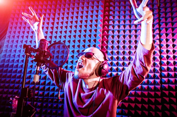 Kayıt stüdyosu olarak bir mikrofon ile şarkıcı söylüyor. Modern arka plan