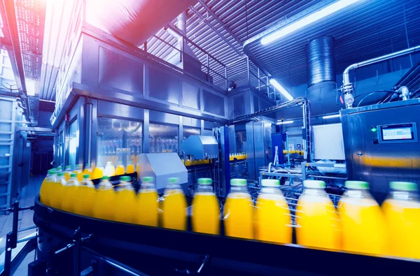 Beverage factory interior. Conveyor with bottles for juice or water. Modern equipments