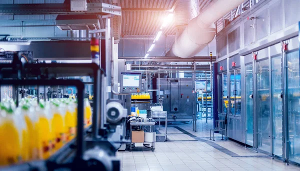 Beverage factory interior. Conveyor with bottles for juice or water. Modern equipments