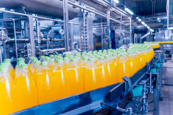 Beverage factory interior. Conveyor with bottles for juice or water. Modern equipments