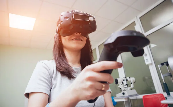 Eye treatment. Patient in virtual reality goggles