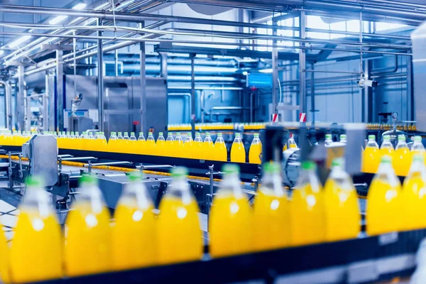 Beverage factory interior. Conveyor with bottles for juice or water. Modern equipments