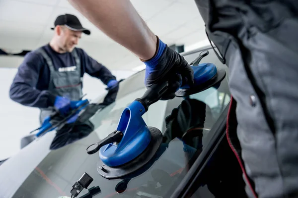 Ön cam veya cam otomatik servis istasyonu garajında bir araba yerine otomobil özel işçi. Arka plan