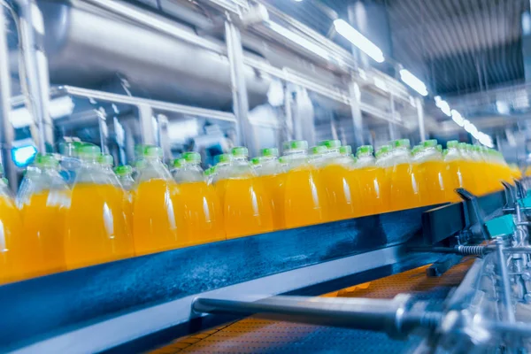 Beverage factory interior. Conveyor with bottles for juice or water. Modern equipments