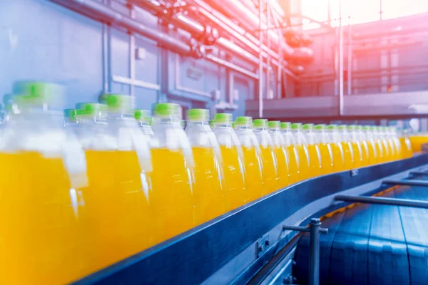 Beverage factory interior. Conveyor with bottles for juice or water. Modern equipments