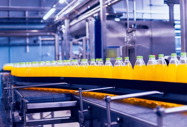 Beverage factory interior. Conveyor with bottles for juice or water. Modern equipments