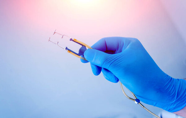 Ophthalmic eye surgery equipment. Surgeon holds an instrument. Surgical cataract treatment.