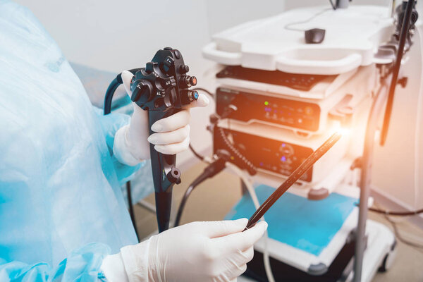 Endoscopy at the hospital. Doctor holding endoscope before gastroscopy. Medical examination