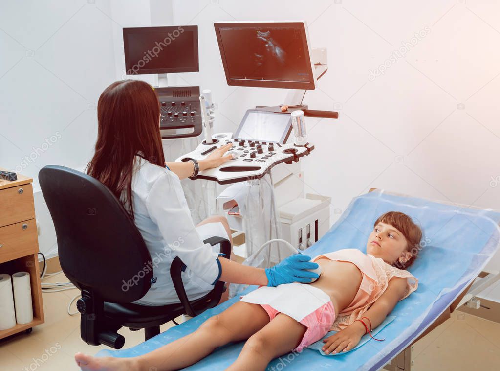 Medical exam of a little girl by ultrasound equipment. Diagnostic, healthcare, medical service