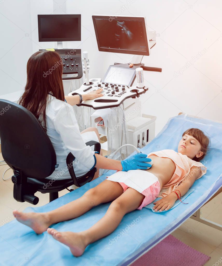 Medical exam of a little girl by ultrasound equipment. Diagnostic, healthcare, medical service