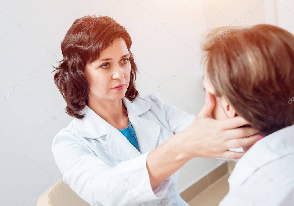 Neurological examination. The neurologist testing reflexes on a female patient using a hammer. Diagnostic, healthcare, medical service