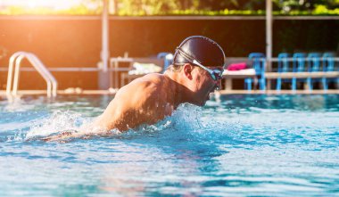 Yüzme havuzunda yüzen genç sporcu, aktif spor konsepti  