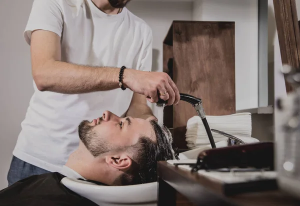 Young Man Trendy Haircut Barber Shop Barber Washes Customer Head — Stock Photo, Image