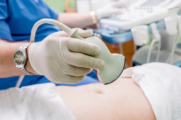 Ultrasound scanner in the hands of a doctor. Diagnostics. Sonography.