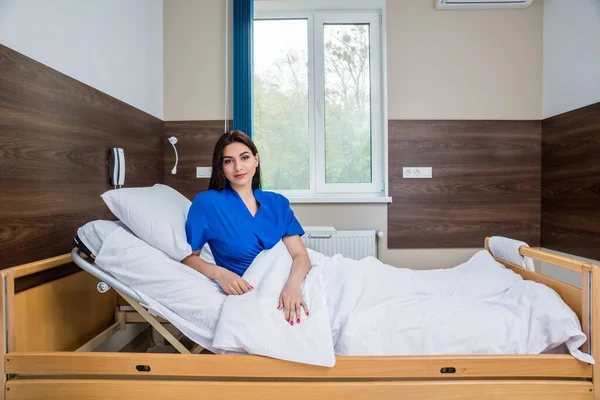 Patient in a hospital bed. Young caucasian woman. Connected with nurse