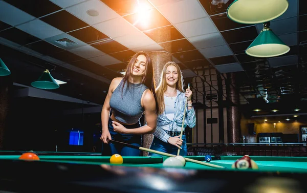 Two Young Women Playing Billiard Billiard Room Background — 스톡 사진