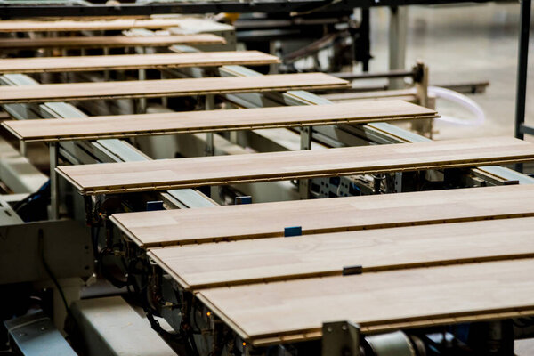 Production line of wooden floor factory, industrial background
