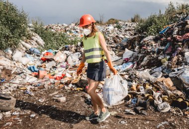 Kadın gönüllü plastik çöpleri temizlemeye yardım ediyor. Dünya günü ve ekoloji kavramı