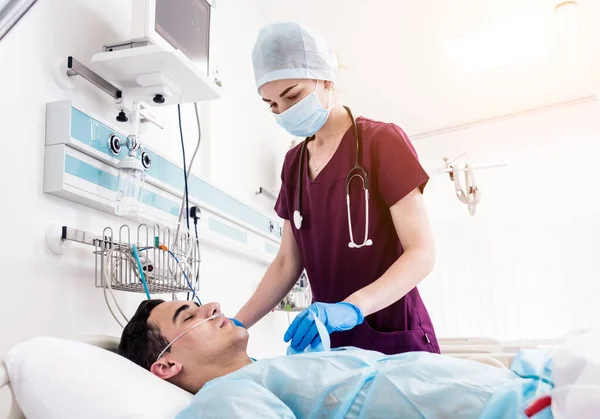 Doctors give resuscitation to a male patient in the emergency room. Cardiac massage