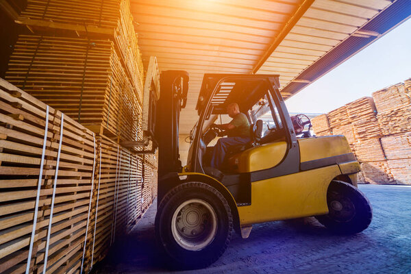 Forklift loader load lumber into a dry kiln. Wood drying in cont