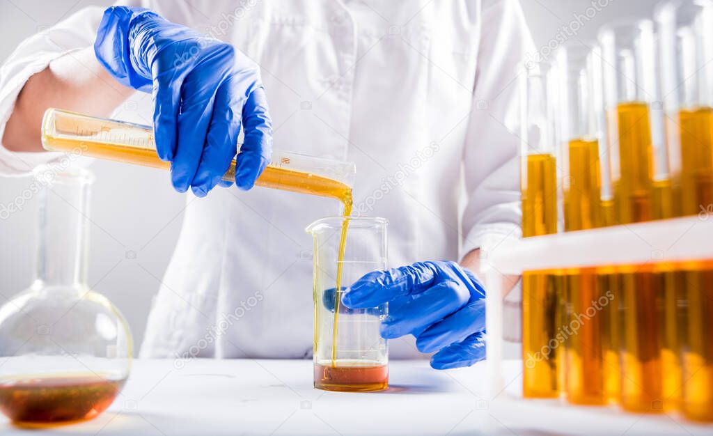 close up of scientist pouring organic oil. Beauty and cosmetics sciences