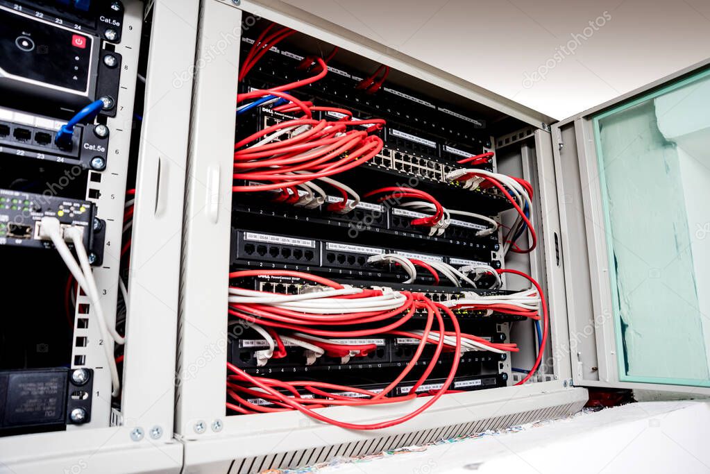 Network switch and ethernet cables in red and white colors