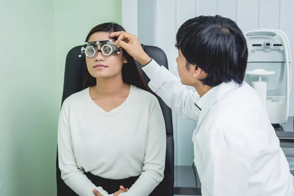 Konsultation beim Augenarzt. Junge asiatische Frau und Arzt — Stockfoto