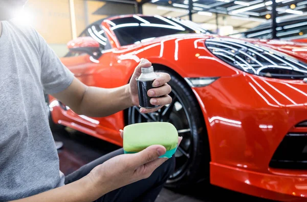 Trabalhador de serviço de carro aplicando revestimento nano em um detalhe do carro — Fotografia de Stock
