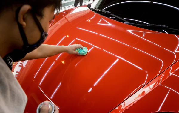 Trabajador de servicio de coches aplicando nano recubrimiento en un detalle del coche — Foto de Stock