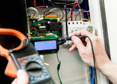 Adam elektrik santralini otomatik şalterlerle onarıyor..