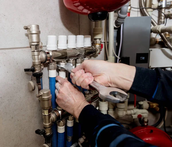 Heating engineer installing modern heating system in boiler room. — Stock Photo, Image