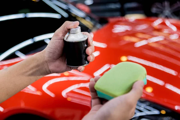 Trabajador de servicio de coches aplicando nano recubrimiento en un detalle del coche —  Fotos de Stock