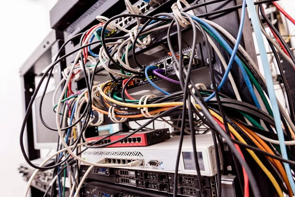 Server room with computers for internet. Network cables connected to switches.