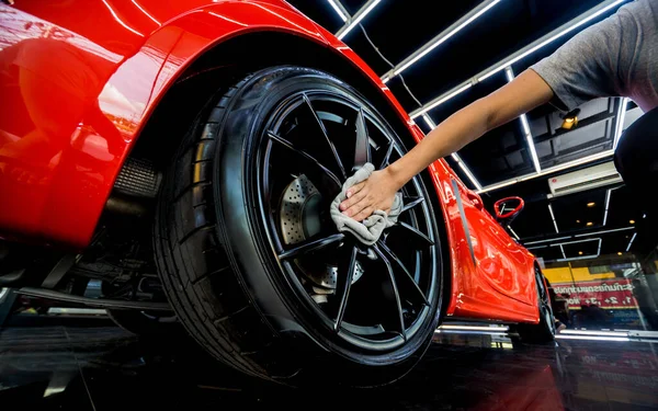 Bilservice arbetare polering bil hjul med microfiber duk. — Stockfoto