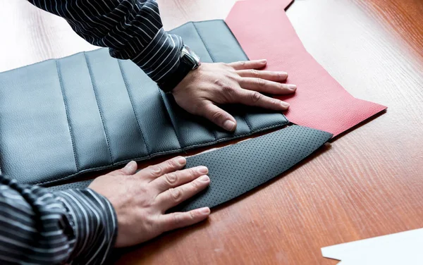Diseñador sastrería coser las cubiertas del asiento. El hombre utiliza la máquina de coser para su trabajo. — Foto de Stock