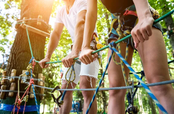 Young couple having fun time in adventure rope park. — Stock Photo, Image