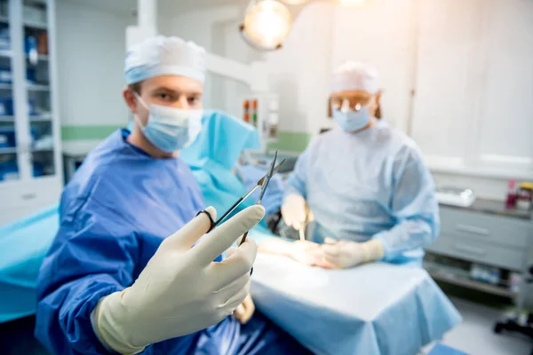 Cirujanos en quirófano tratando de salvar la mano de los pacientes. — Foto de Stock