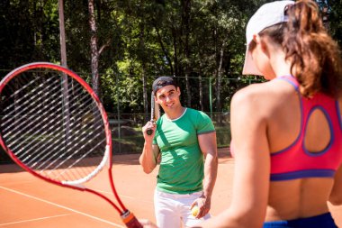 Sahada tenis oynayan genç atletik çift.